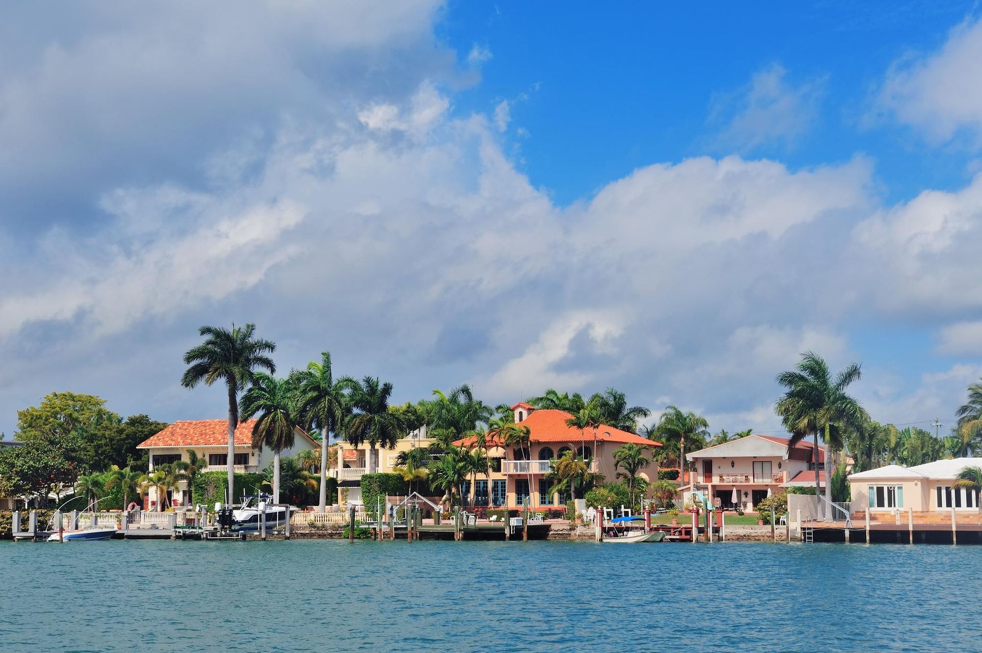 A row of houses on the shore of a body of water